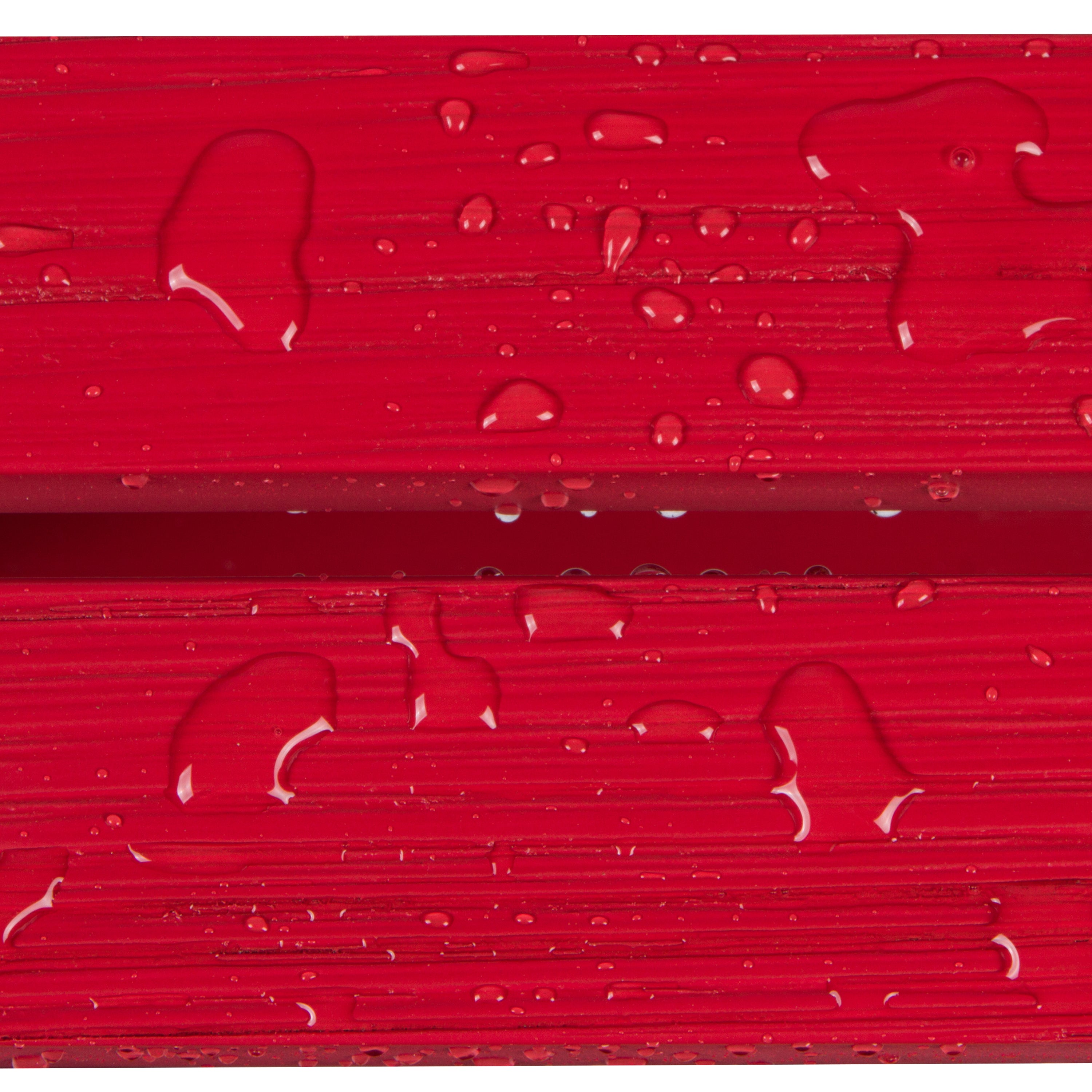 Close-up of glossy red textured material with water droplets on the surface.