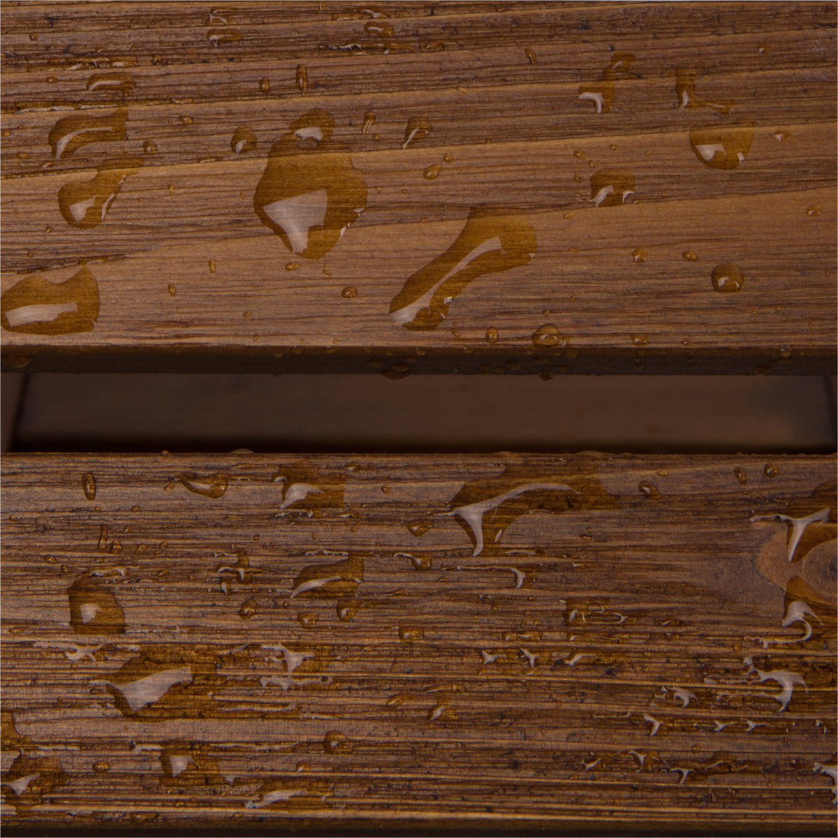 Close-up of a brown wood-grain textured surface with water droplets and a horizontal slot or groove running through the center.