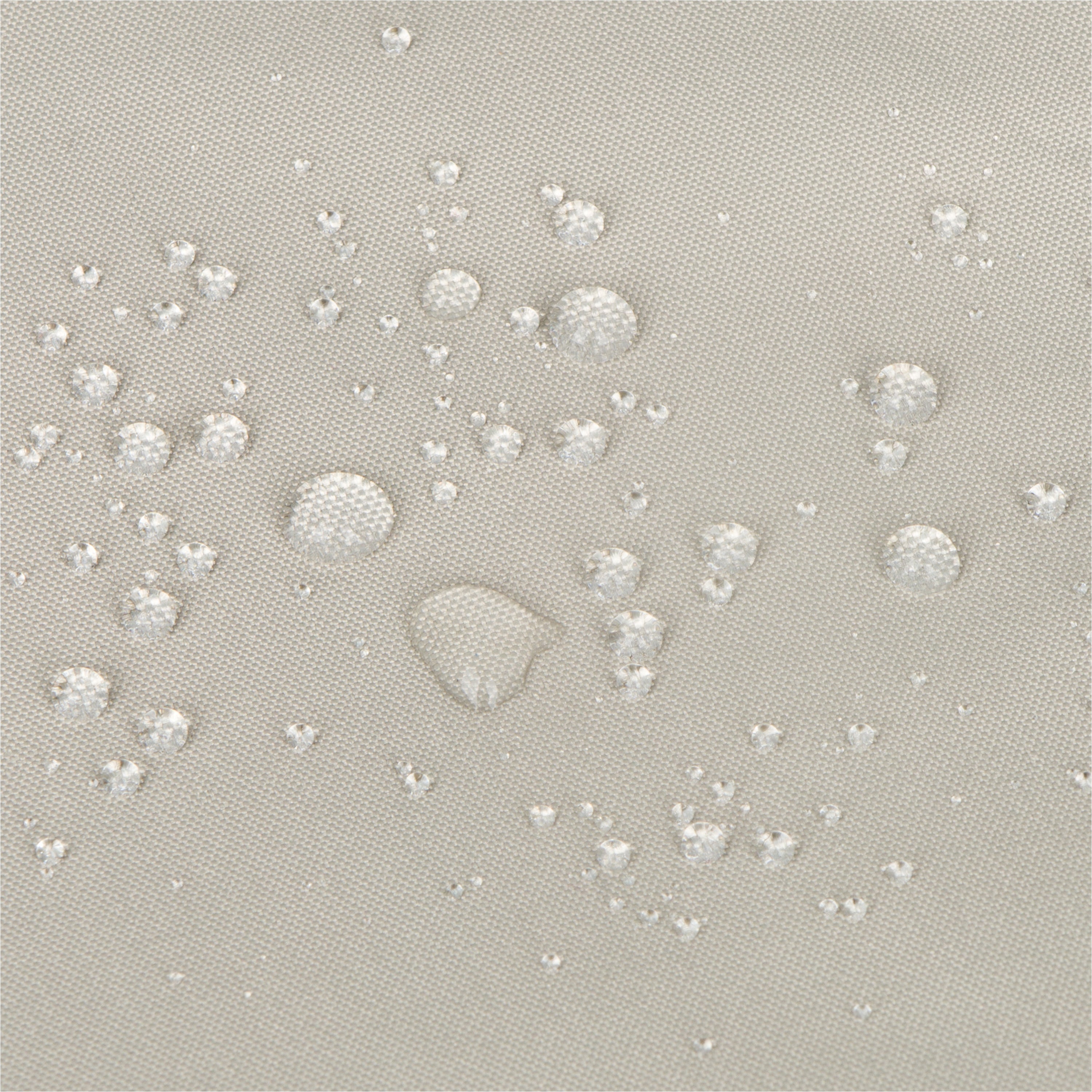 Close-up of a light gray fabric surface with scattered clear water droplets showing a repellent, water-repellant finish.