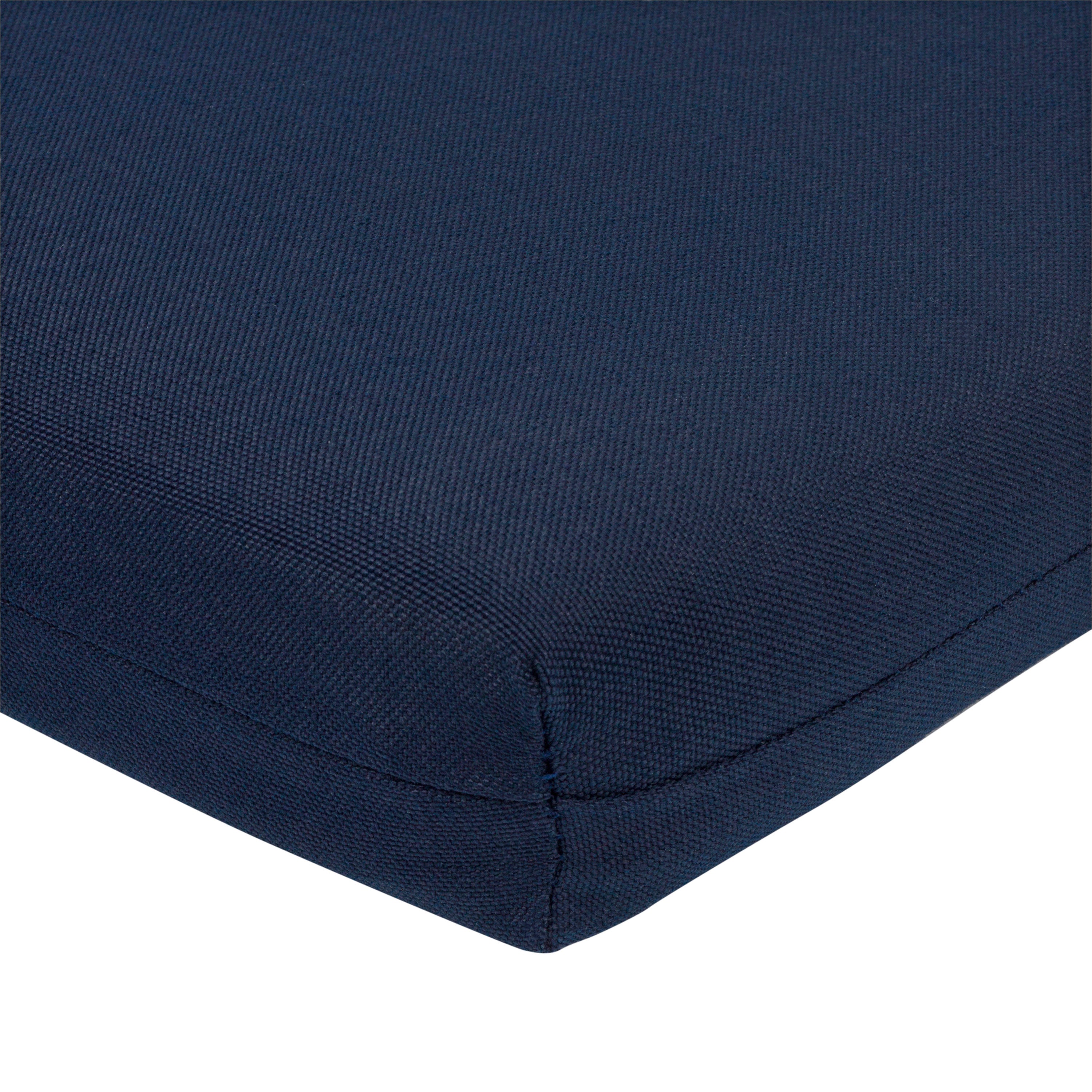 Close-up of a navy blue textured fabric cushion corner with a clean white background.
