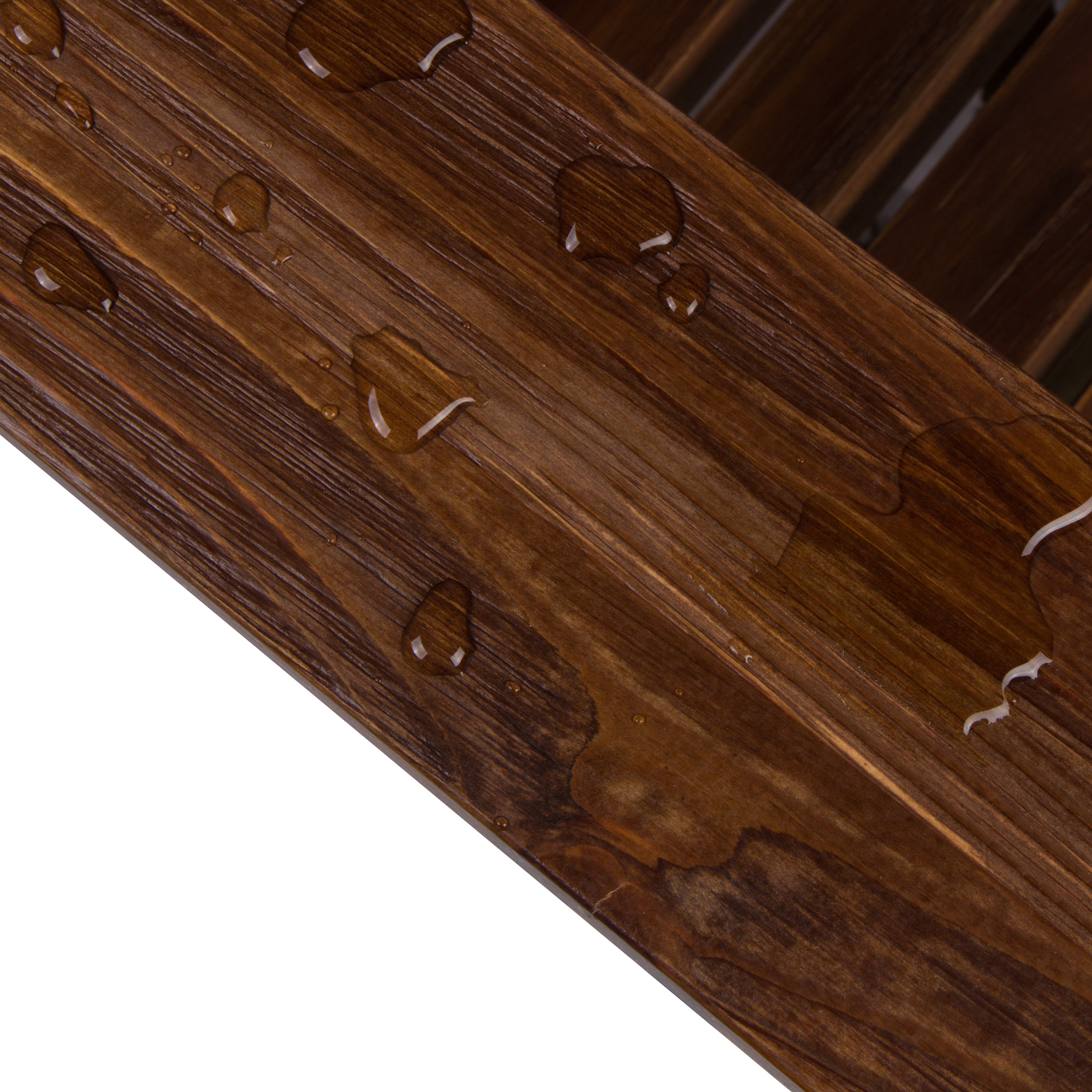 Close-up of a wooden product with engraved patterns showcasing the water resistant finish on a white background