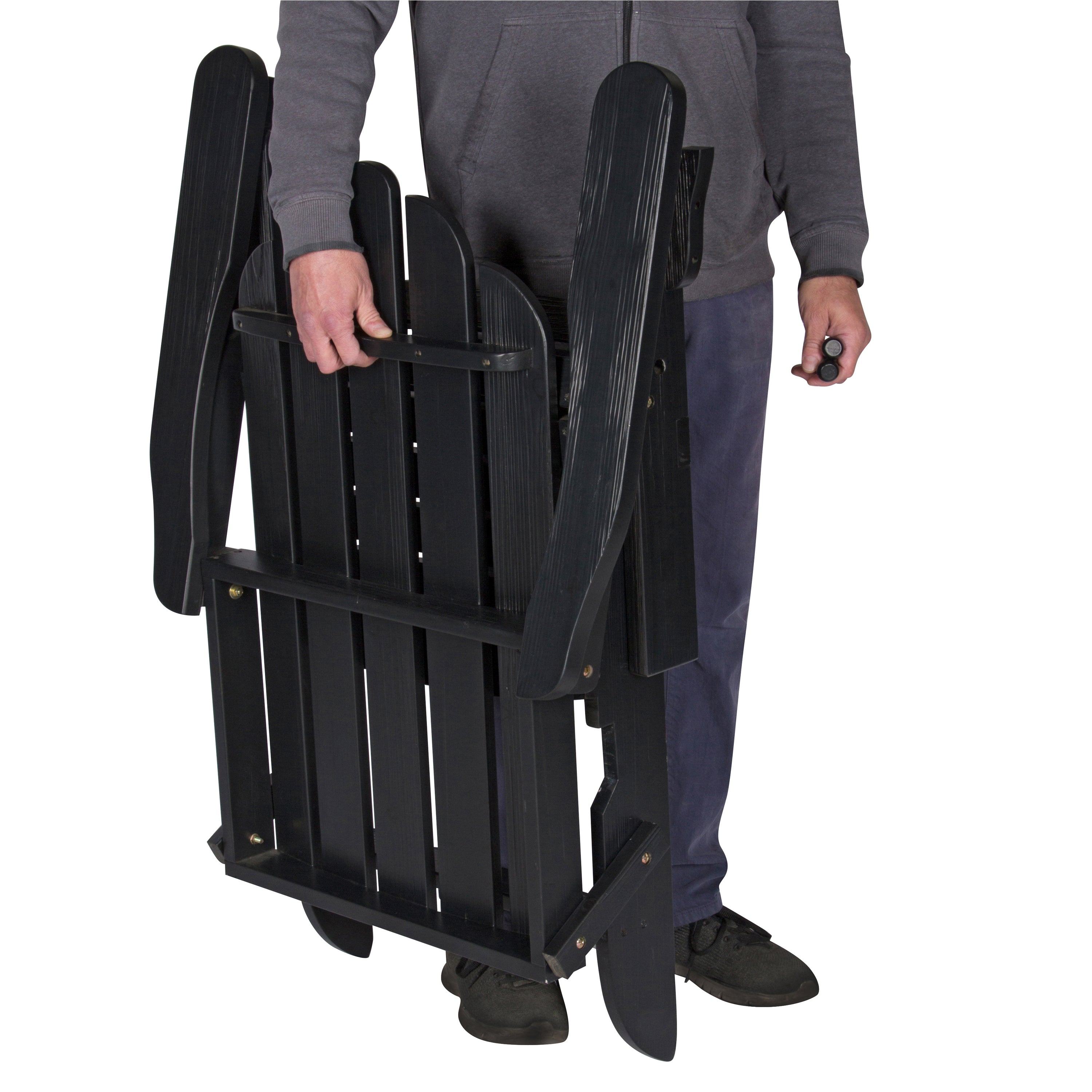 Person holding a black folding chair on a white background