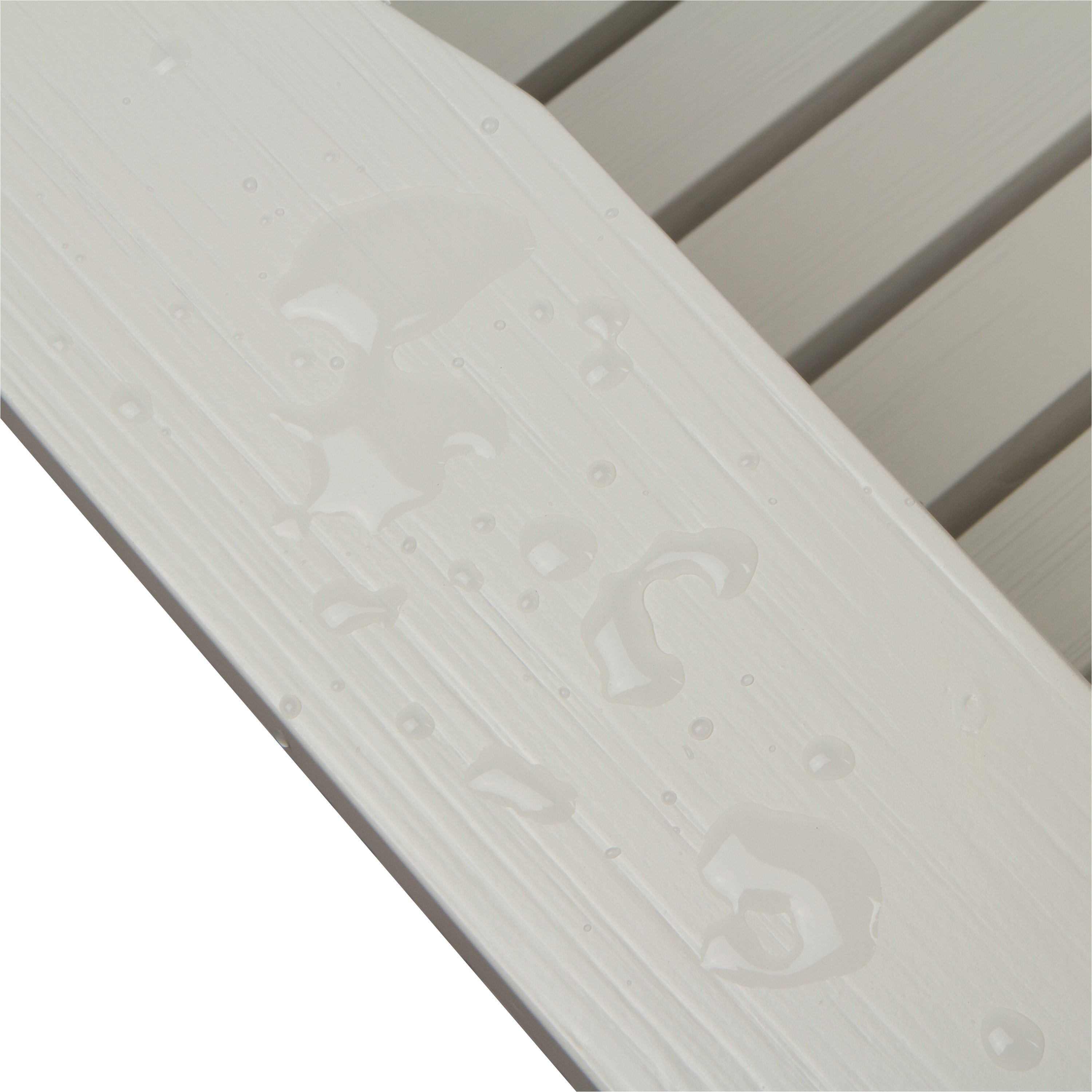 Close-up of a white textured slatted surface with water droplets on a white background.