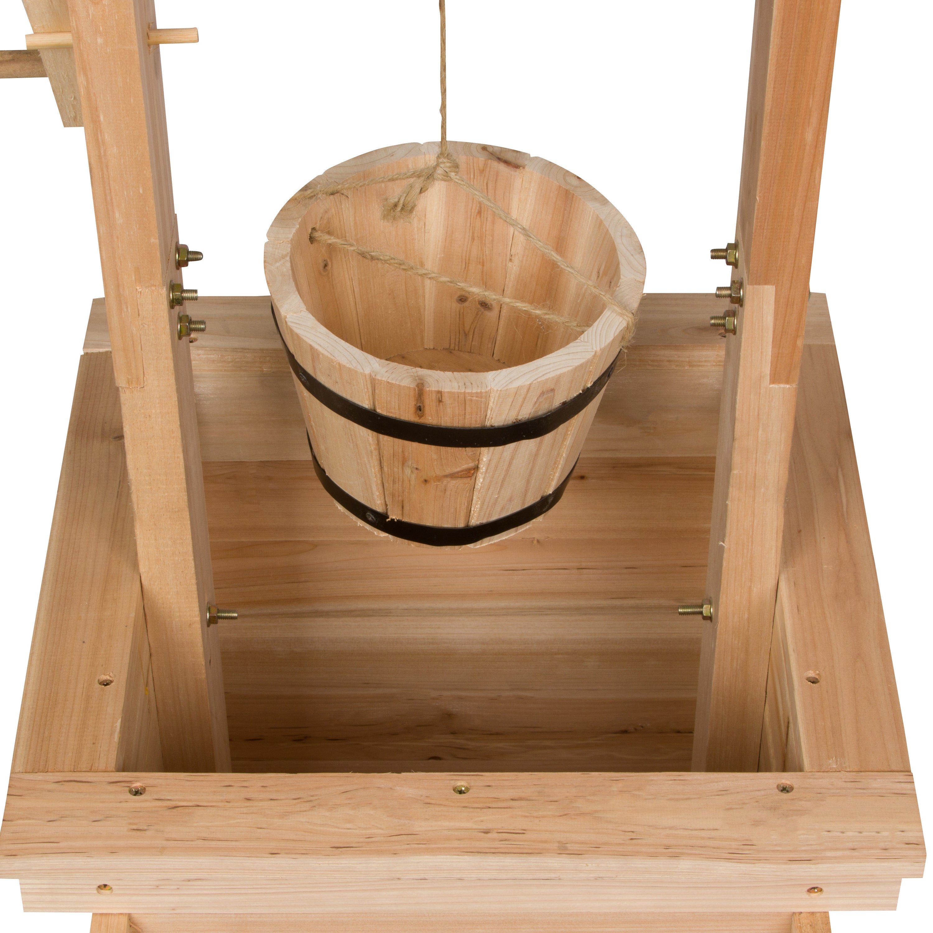A wooden bucket with black metal bands hanging from a wooden frame on a white background.