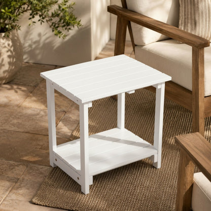 White outdoor side table with a wooden chair on a patio 