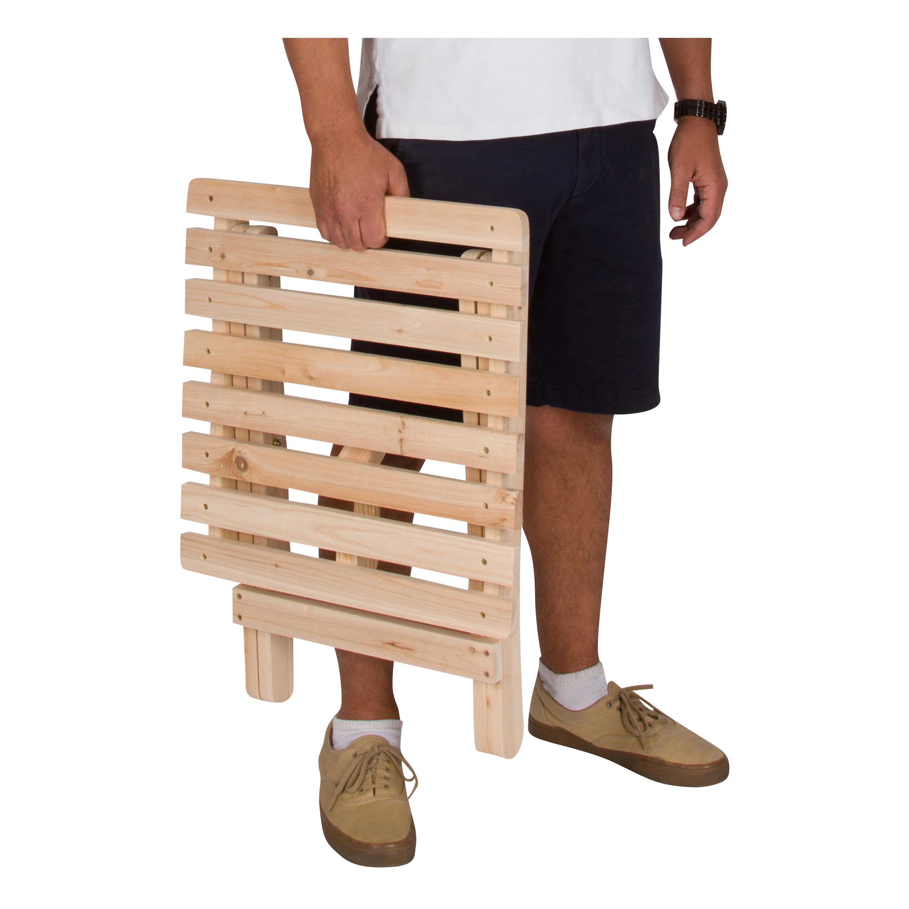 Person holding a wooden folding table on a white background 