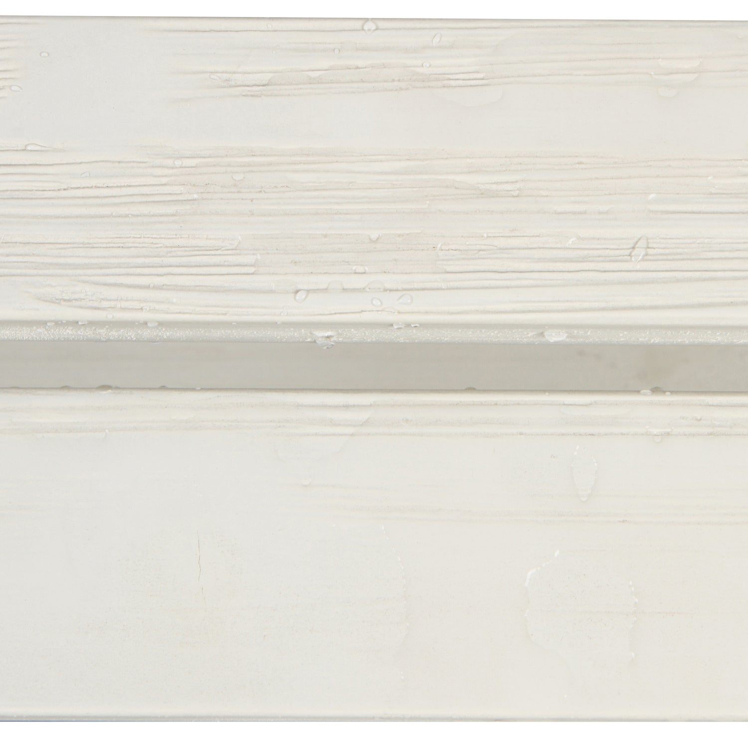 A close-up of a white textured surface with horizontal brushstroke patterns and a subtle horizontal seam or edge. 
