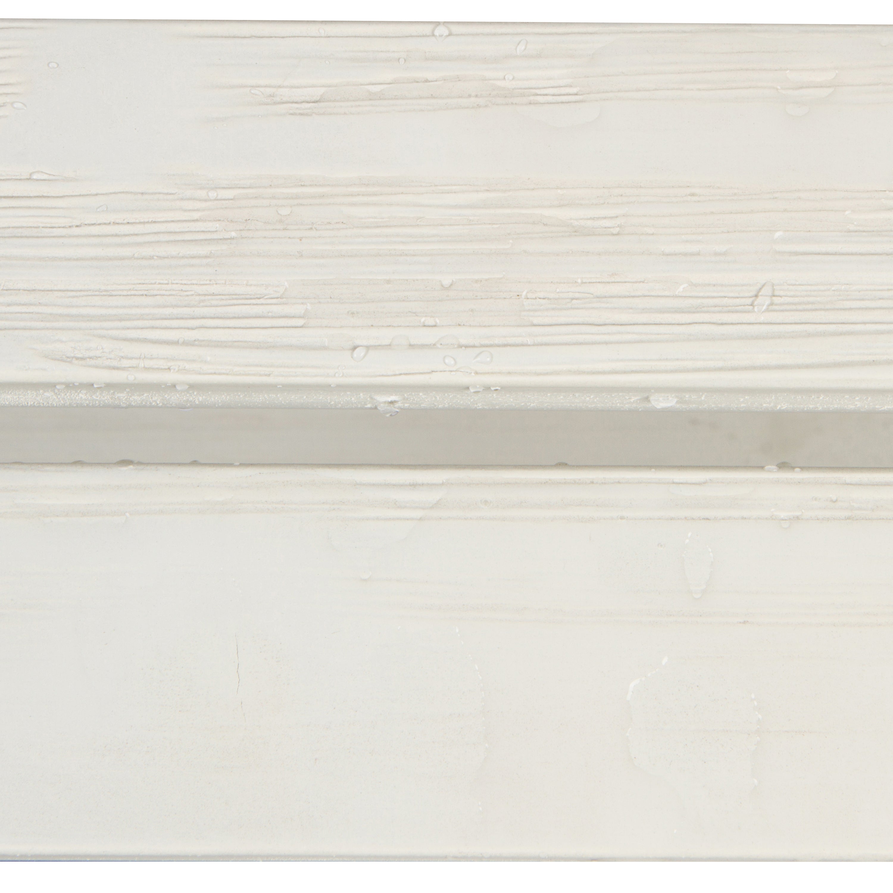 A close-up of a white textured surface with horizontal brushstroke patterns and a subtle horizontal seam or edge. 