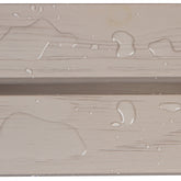 Close-up of a beige wood-textured surface with water droplets and a horizontal seam. 