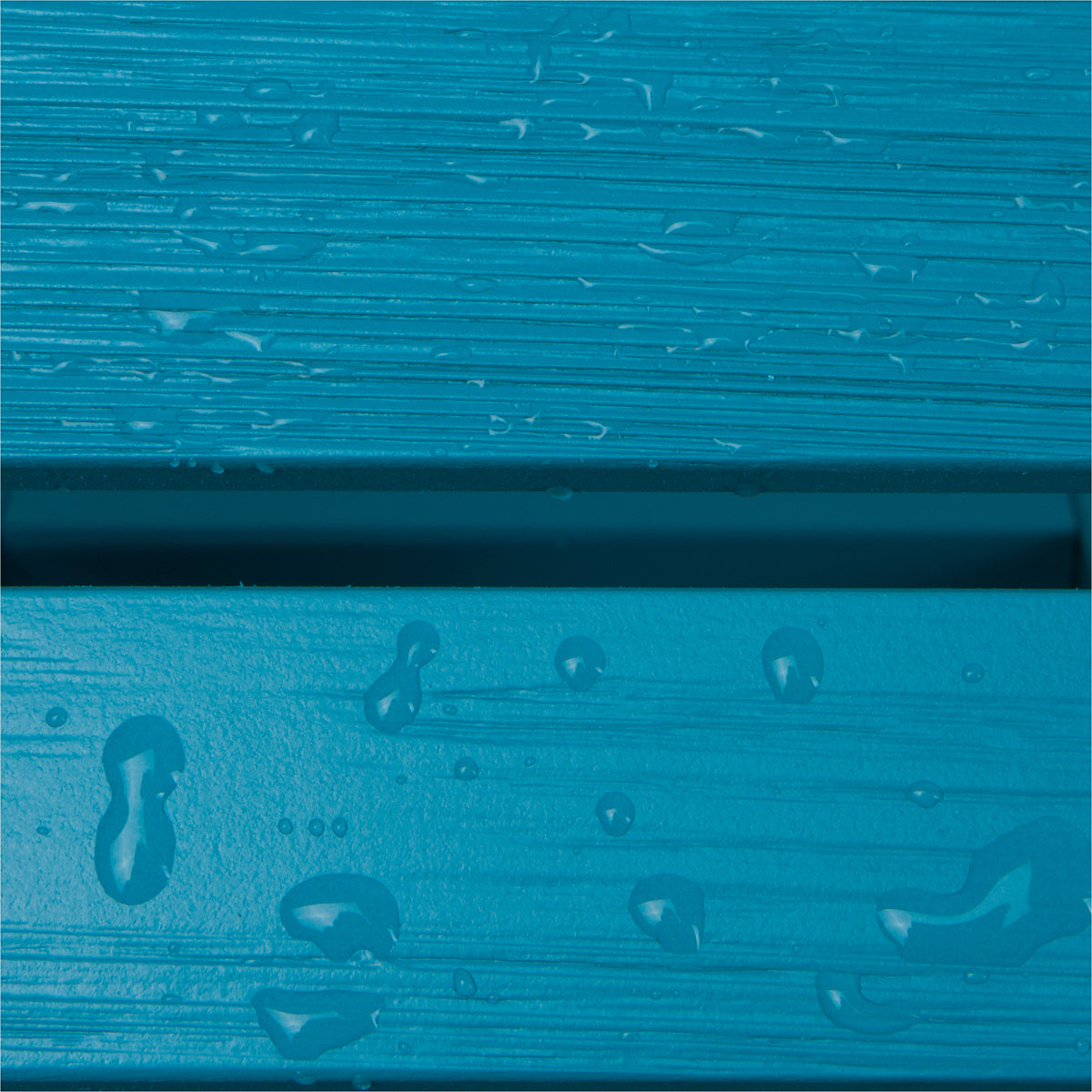 Close-up of bright blue textured material with horizontal ridges and water droplets, showing a glossy surface between two panels. 