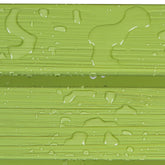Close-up of a glossy light green textured surface with water droplets and horizontal ridges. 