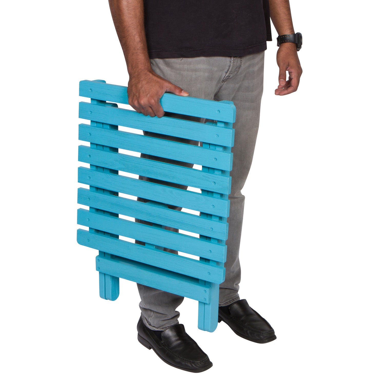 Person holding a blue wooden side table on a white background 