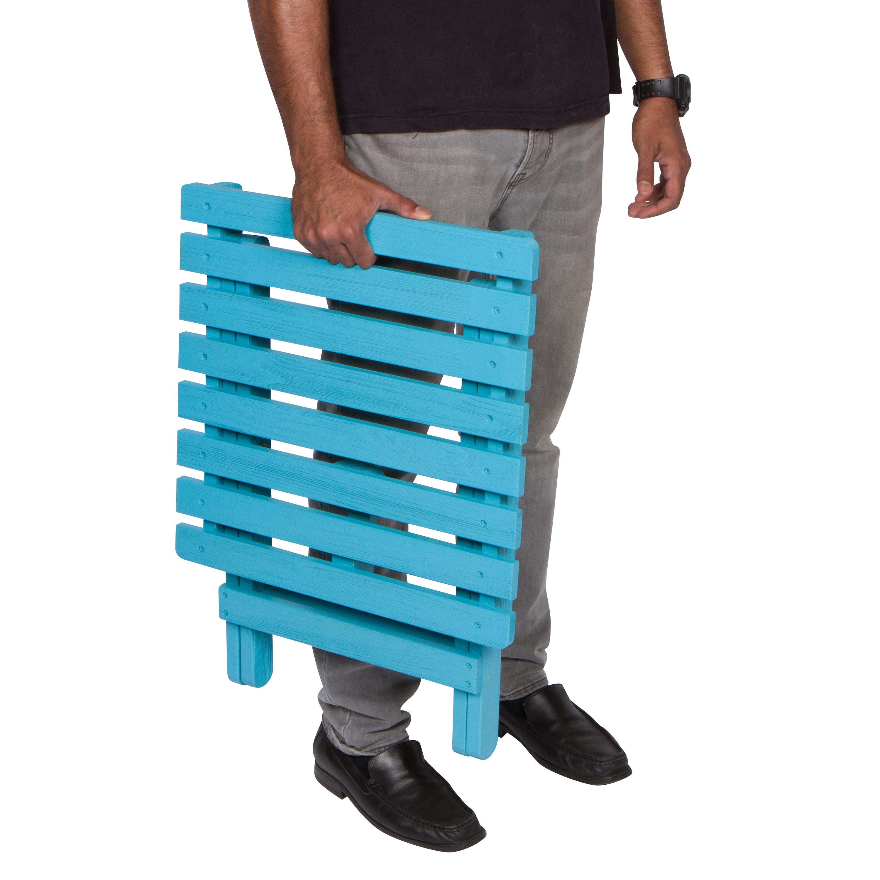 Person holding a blue wooden side table on a white background 