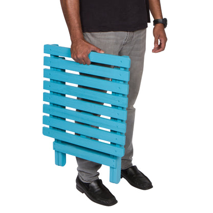 Person holding a blue wooden side table on a white background 