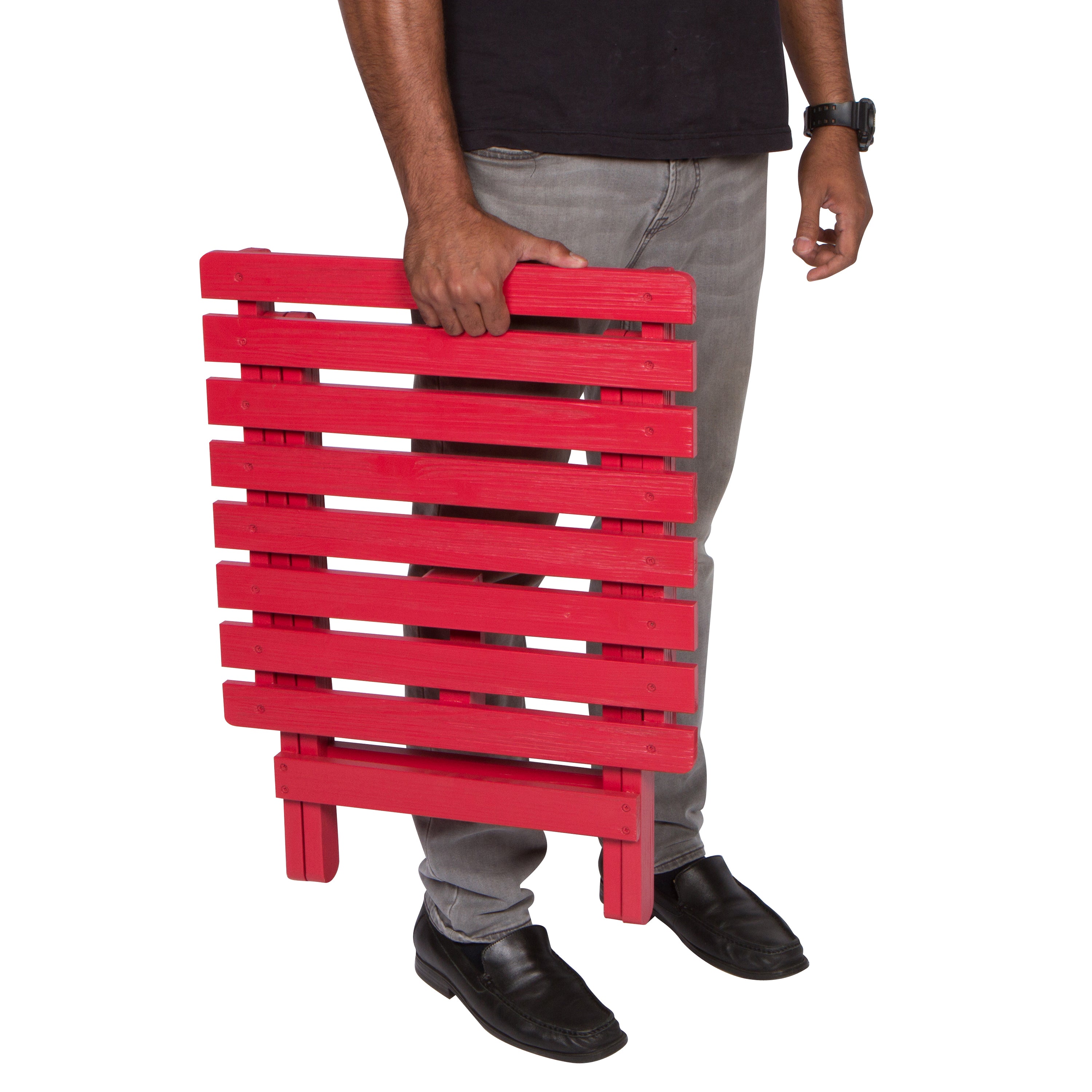 A person holding a bright red folding slatted table against a plain white background. 