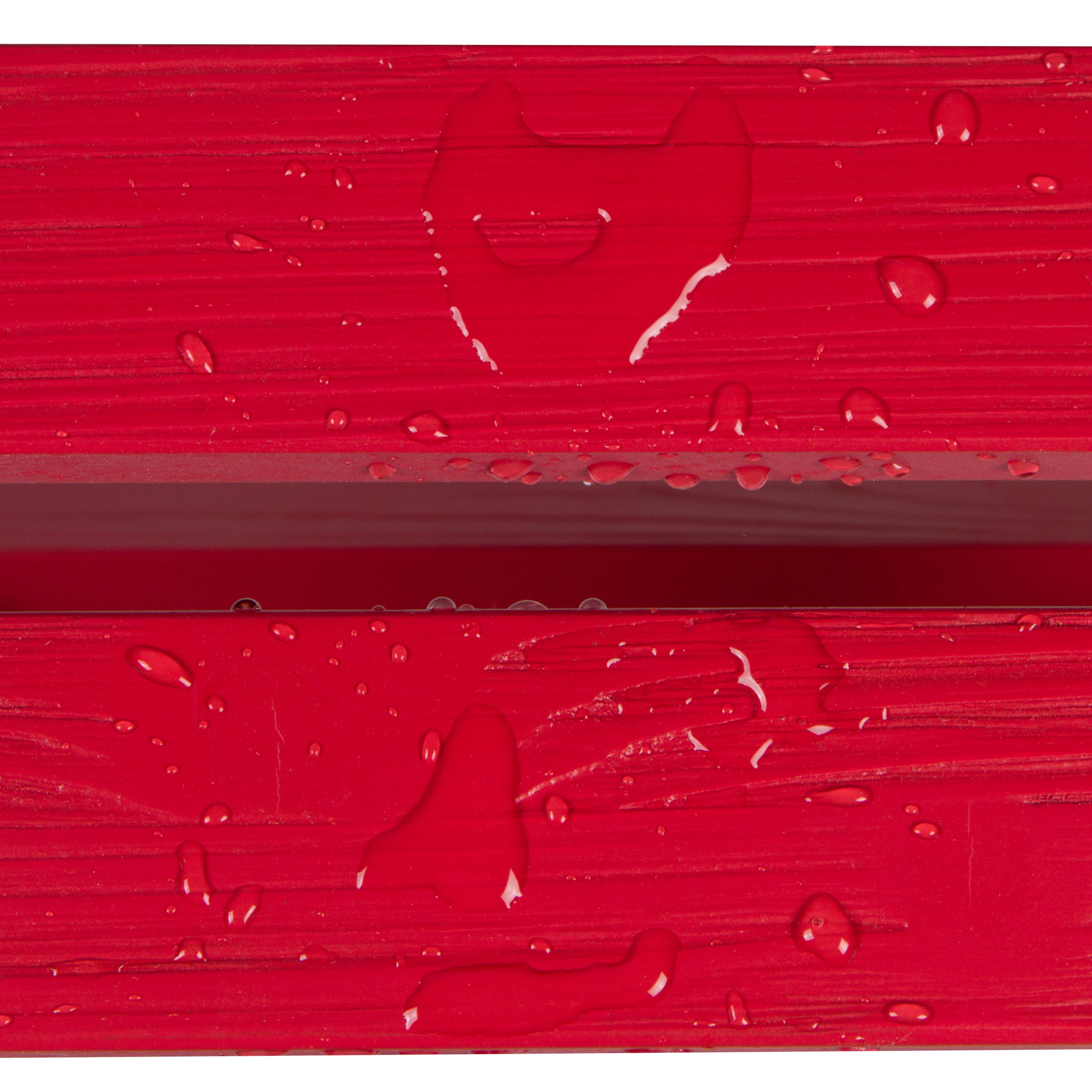 Close-up of a bright red textured surface with water droplets and a faint heart-shaped impression, likely showing a material finish or protective coating. 
