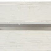 Close-up of a white textured surface with horizontal ridges and a few water droplets, showing a shallow channel or groove in the middle. 