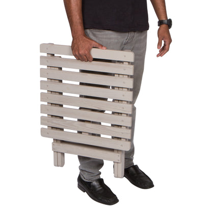 Person holding a wooden folding table on a white background 
