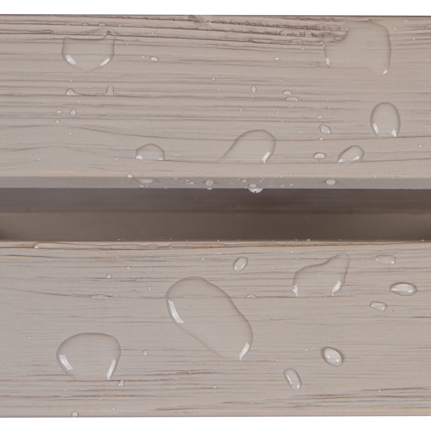 Close-up of a light beige wood-grain surface with clear water droplets beading on top, showing a horizontal seam between two panels.  