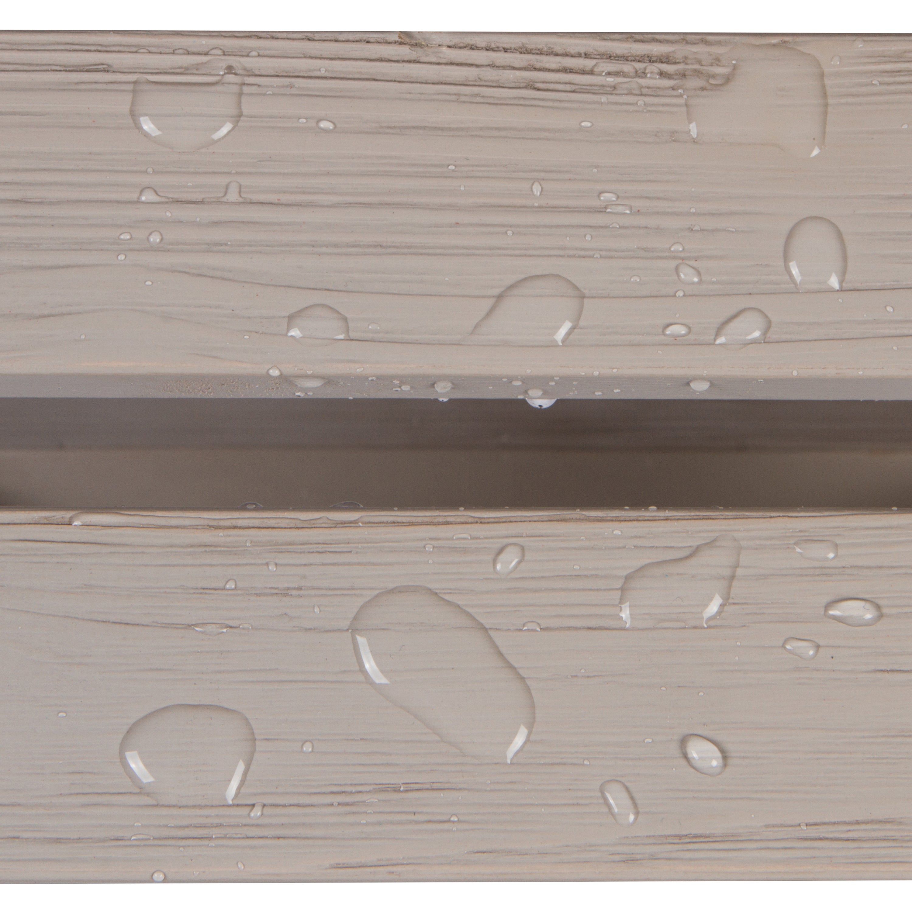 Close-up of a light beige wood-grain surface with clear water droplets beading on top, showing a horizontal seam between two panels.  
