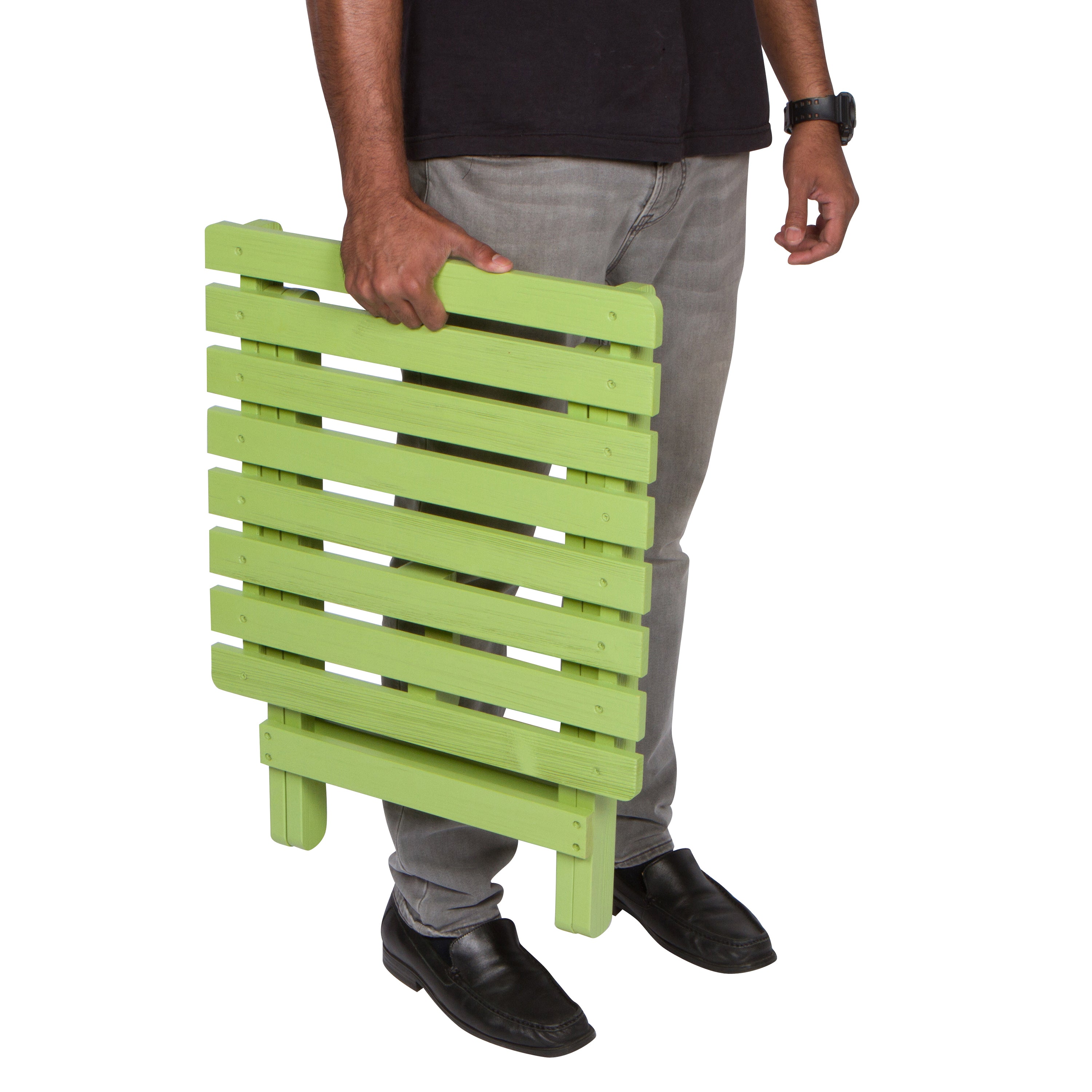 Person holding a green wooden side table against a white background 