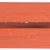 Close-up of a terracotta orange textured surface with water droplets and a water droplet beading up along the edge, demonstrating a waterproof or hydrophobic finish. 