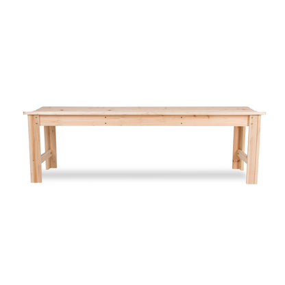 A light natural wood bench with a rectangular top and four legs, shown from a front angle on a white background.  