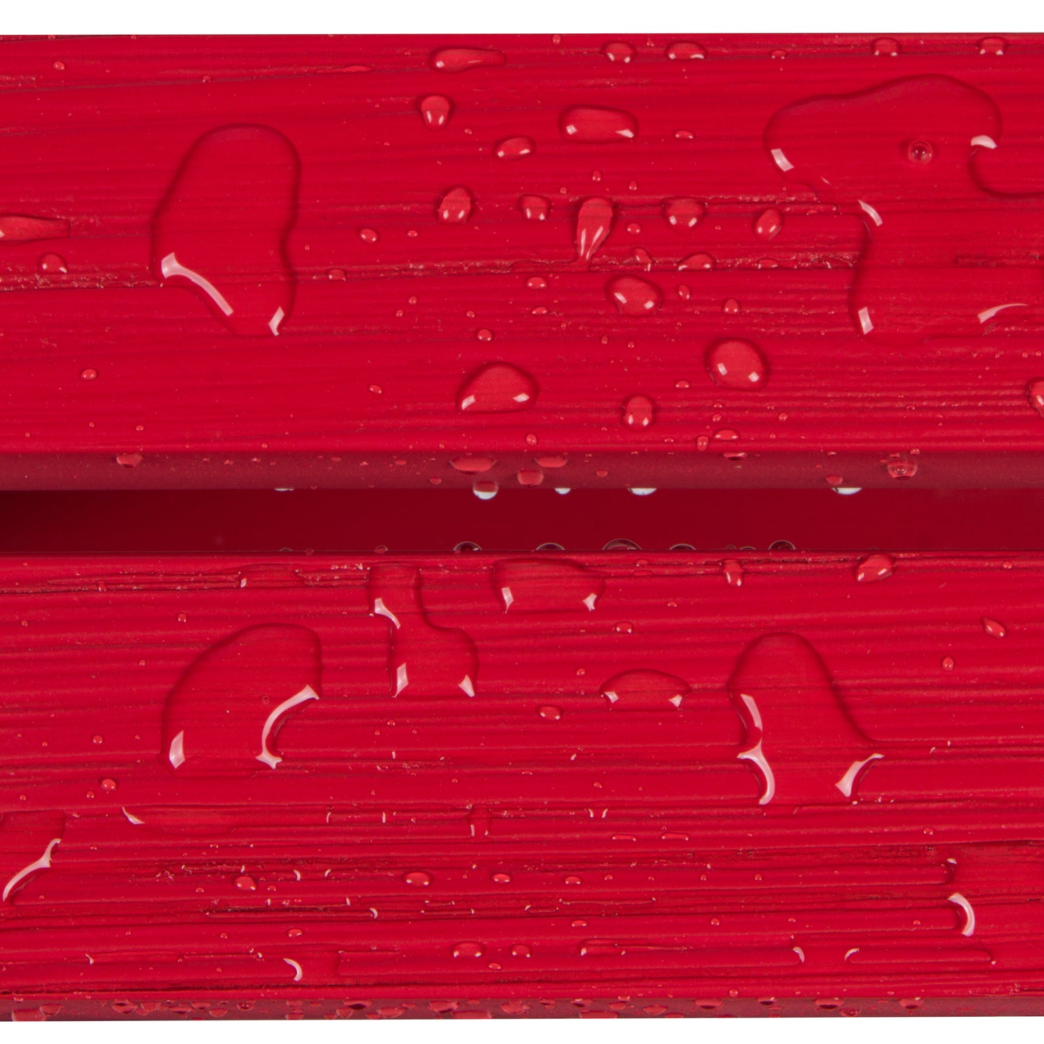 Close-up of glossy red textured material with water droplets on the surface. 