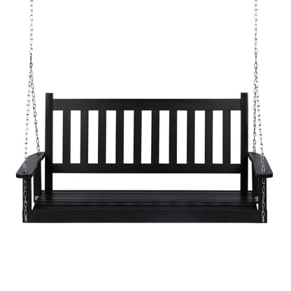 A black wooden porch swing bench suspended by silver metal chains against a plain white background. 
