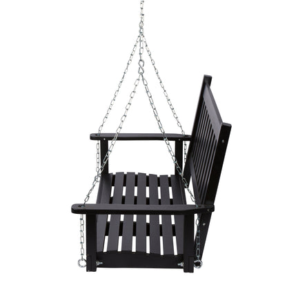 A black wooden hanging porch swing with a slatted seat, backrest, and armrests, suspended by silver metal chains against a plain white background. 