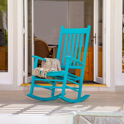 Turquoise rocking chair on a patio with sliding glass doors in the background 