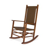A wooden rocking chair with a brown woven wicker seat and backrest, shown from a three-quarter angle on a white background. 