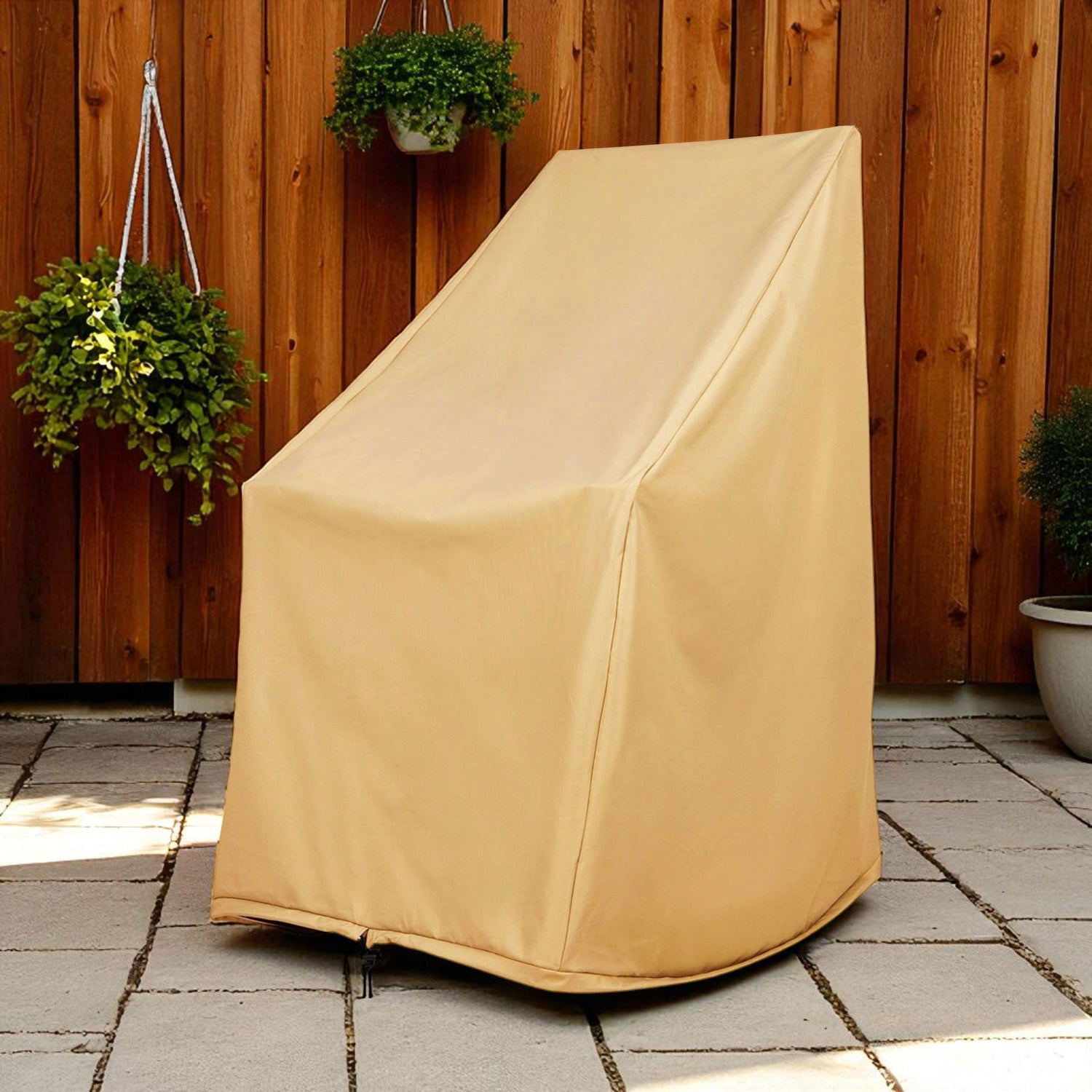 Beige outdoor chair cover on a patio with wooden wall and potted plants. 