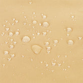 Close-up of a beige textured fabric surface with scattered clear water droplets showing a water-repellent finish. 