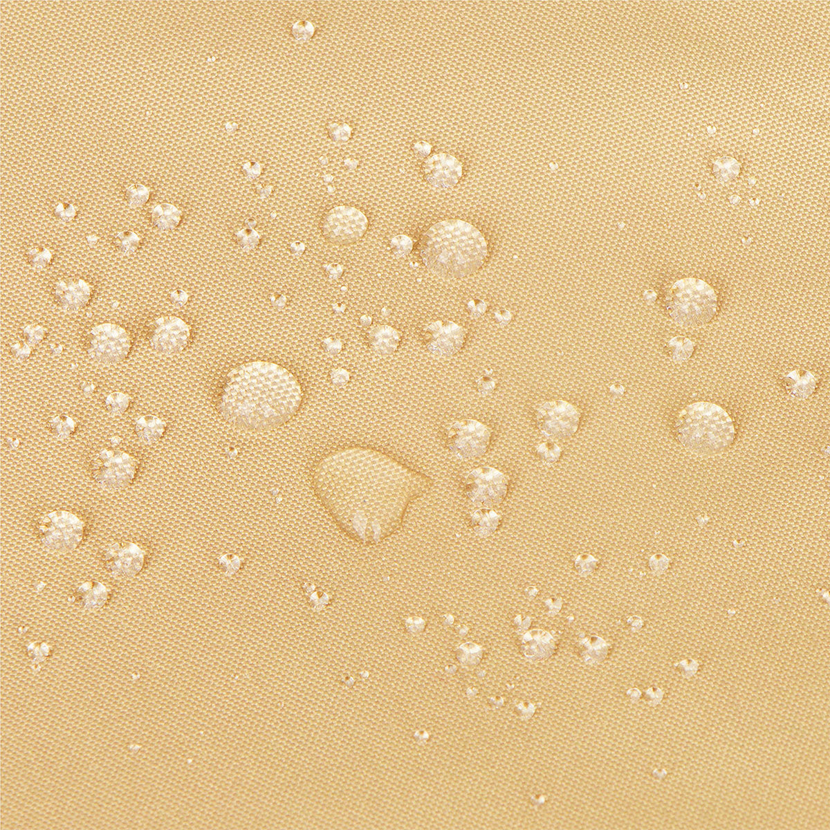Close-up of a beige textured fabric surface with scattered clear water droplets showing a water-repellent finish. 
