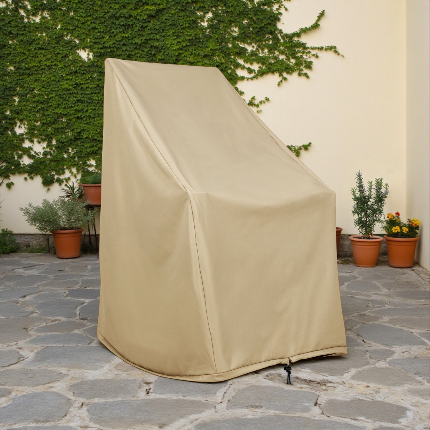 Khaki outdoor furniture cover on a stone patio with plants in the background 