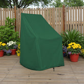 A dark green outdoor garden chair cover standing on a wooden deck in front of a wooden fence, surrounded by potted flowers and plants. 