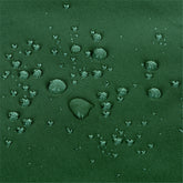Close-up of a dark green textured fabric surface with scattered water droplets on top.  
