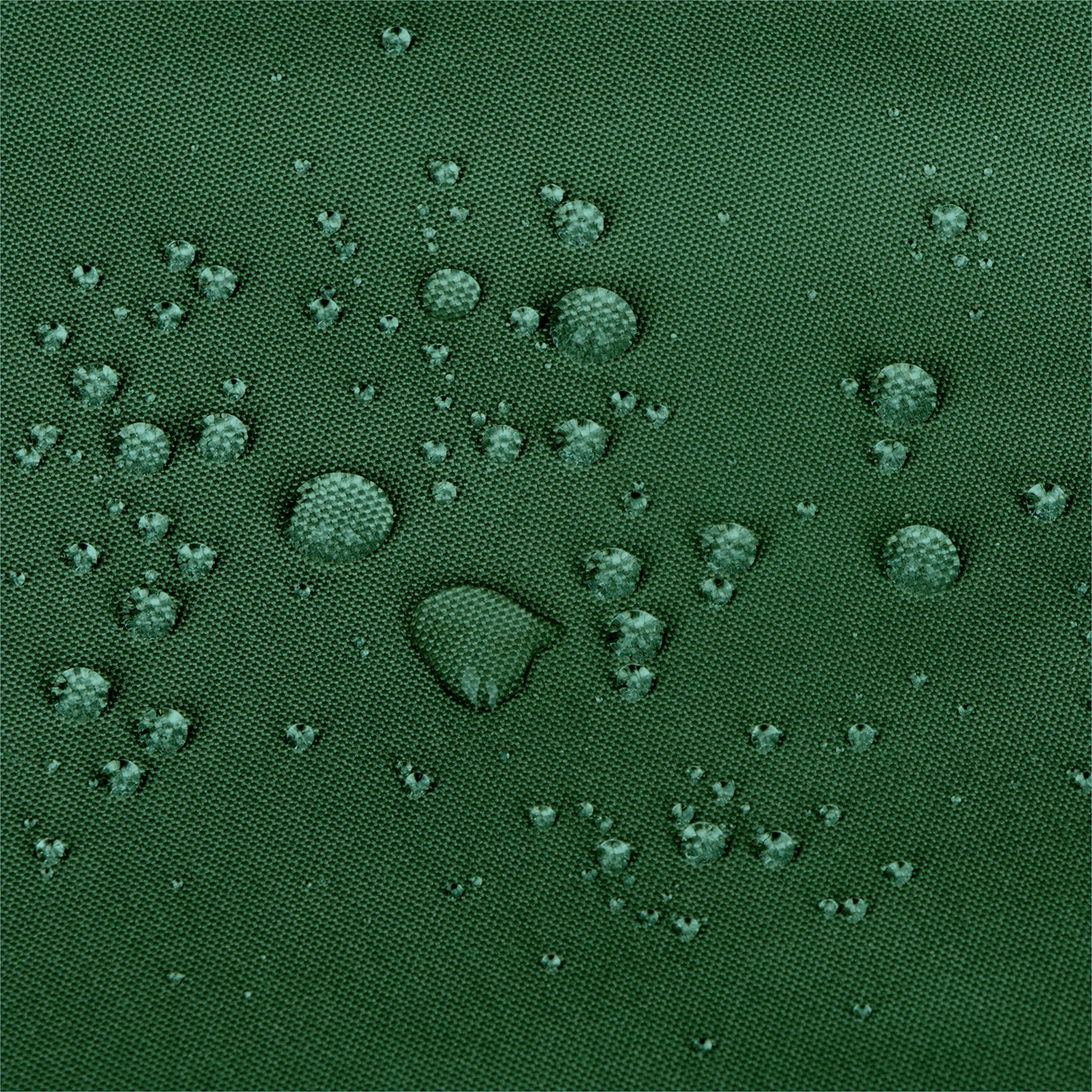 Close-up of a dark green textured fabric surface with scattered water droplets on top.  