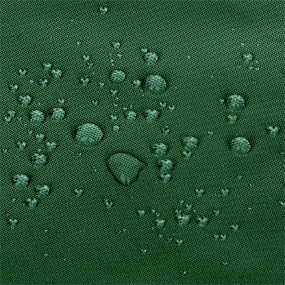 Close-up of a dark green textured fabric surface with scattered water droplets on top.  