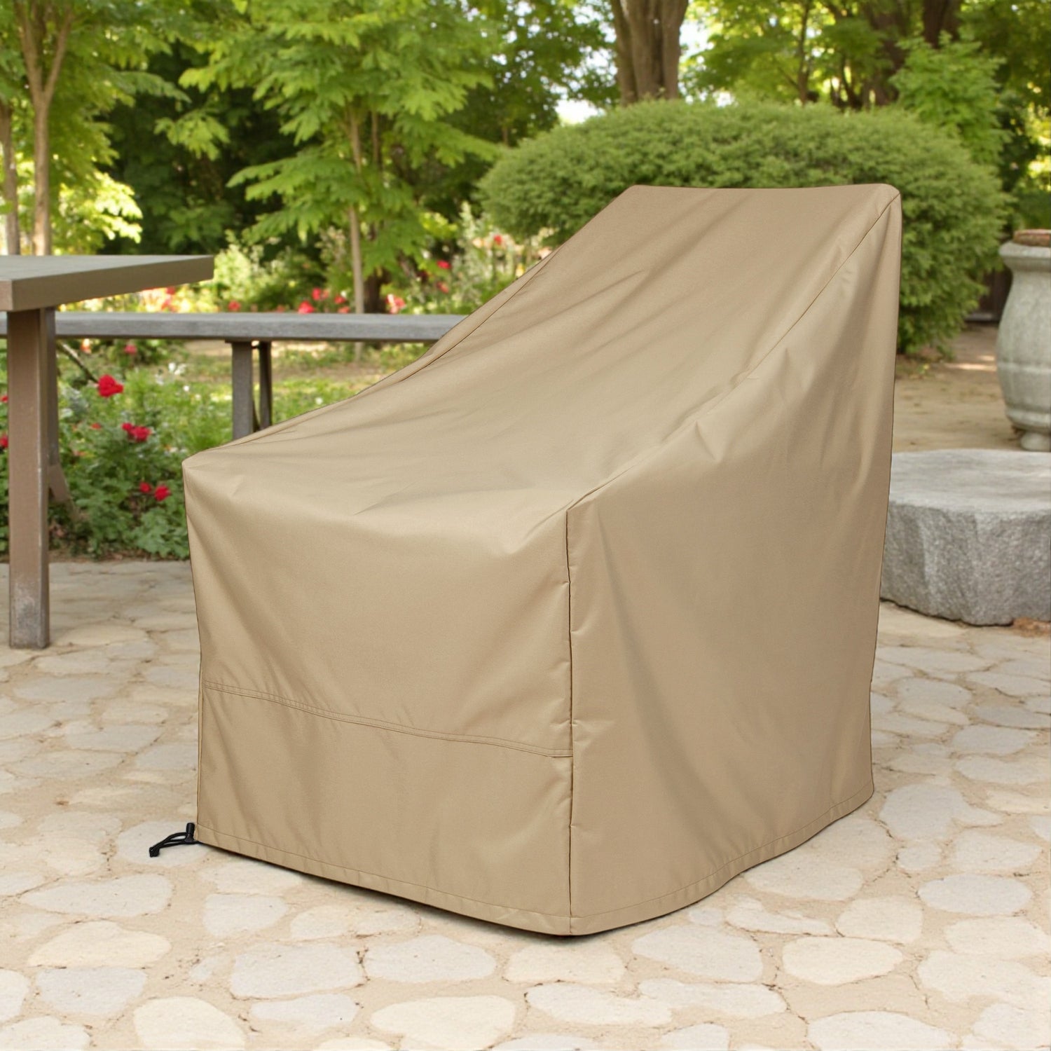 A khaki outdoor patio chair cover, shown fitted on a high-back lounge chair in a garden patio setting. 