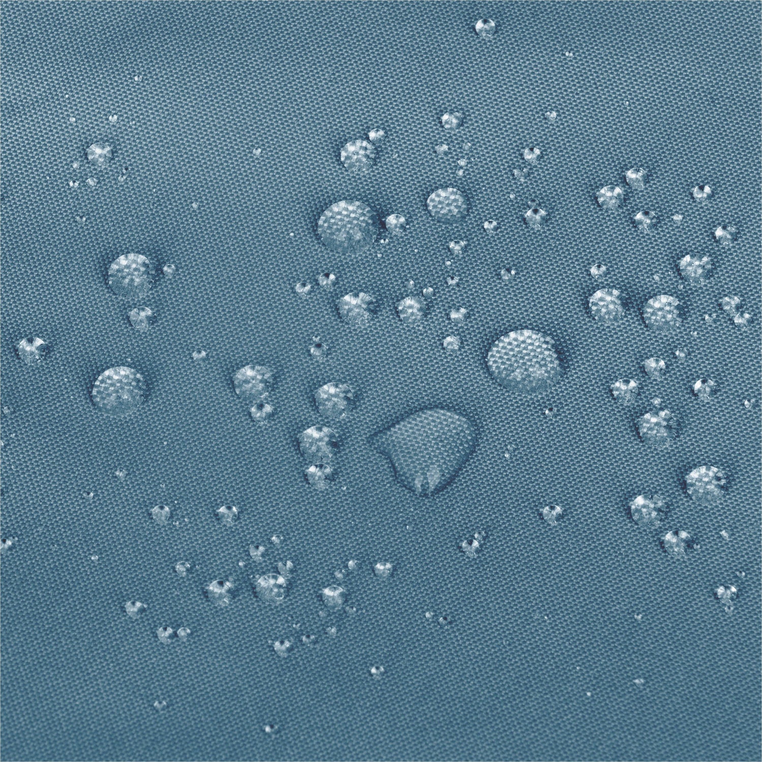 Close-up of a textured blue fabric surface with scattered clear water droplets showing a water-repellent  effect. 