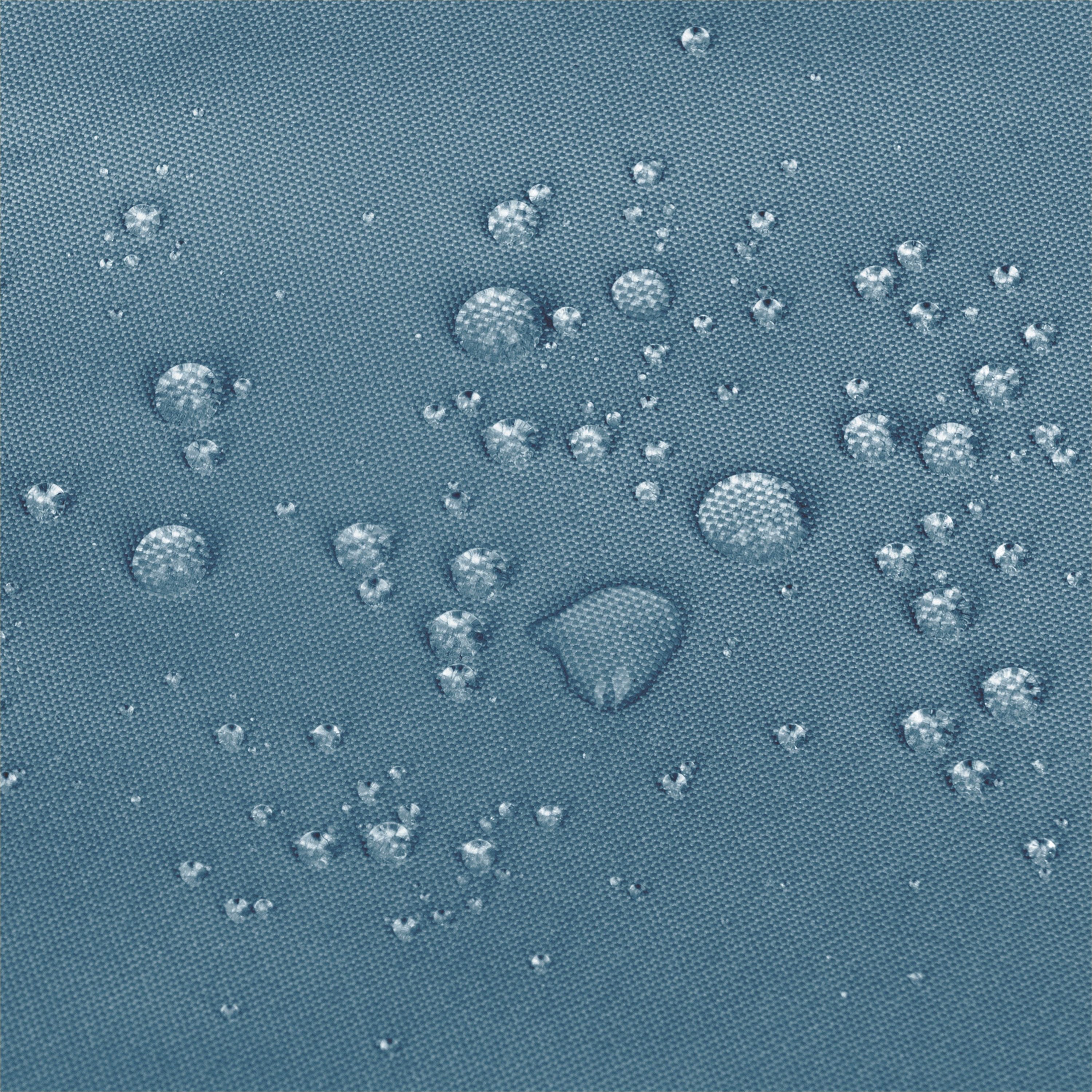 Close-up of a textured blue fabric surface with scattered clear water droplets showing a water-repellent  effect. 