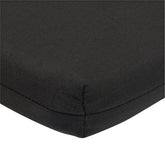 Close-up of a black woven fabric cushion or pad corner with visible stitching on a white background. 