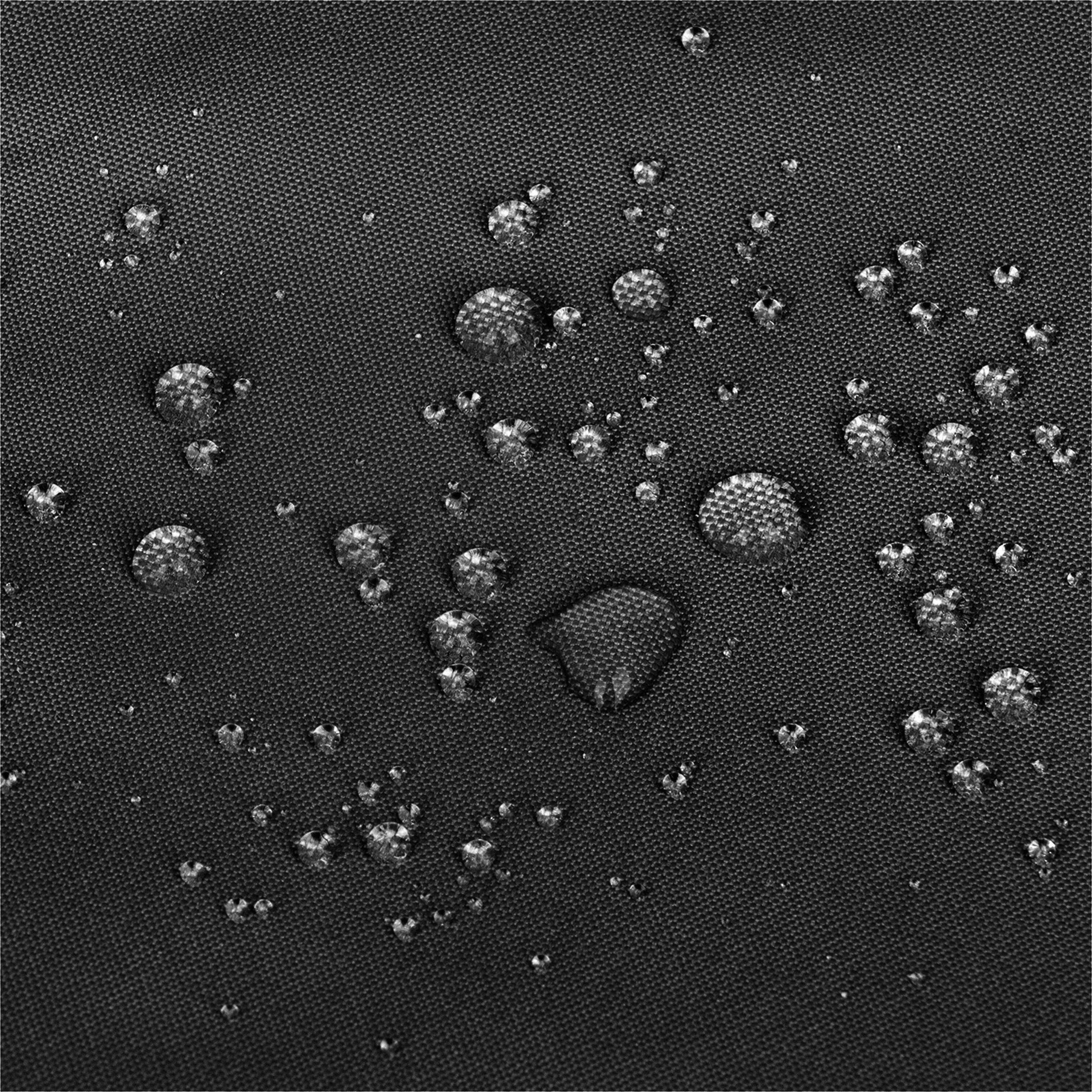 Close-up of a dark textured fabric surface with scattered water droplets showing a water-repellent or hydrophobic effect. 