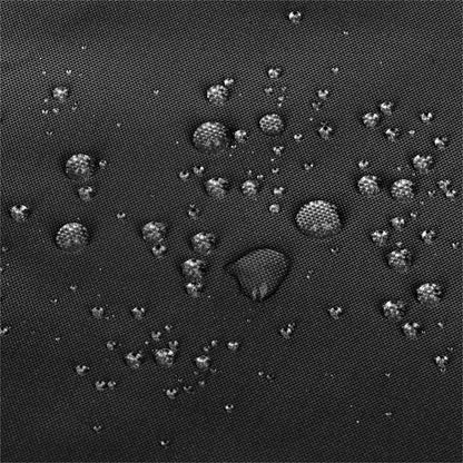Close-up of a dark textured fabric surface with scattered water droplets showing a water-repellent or hydrophobic effect. 
