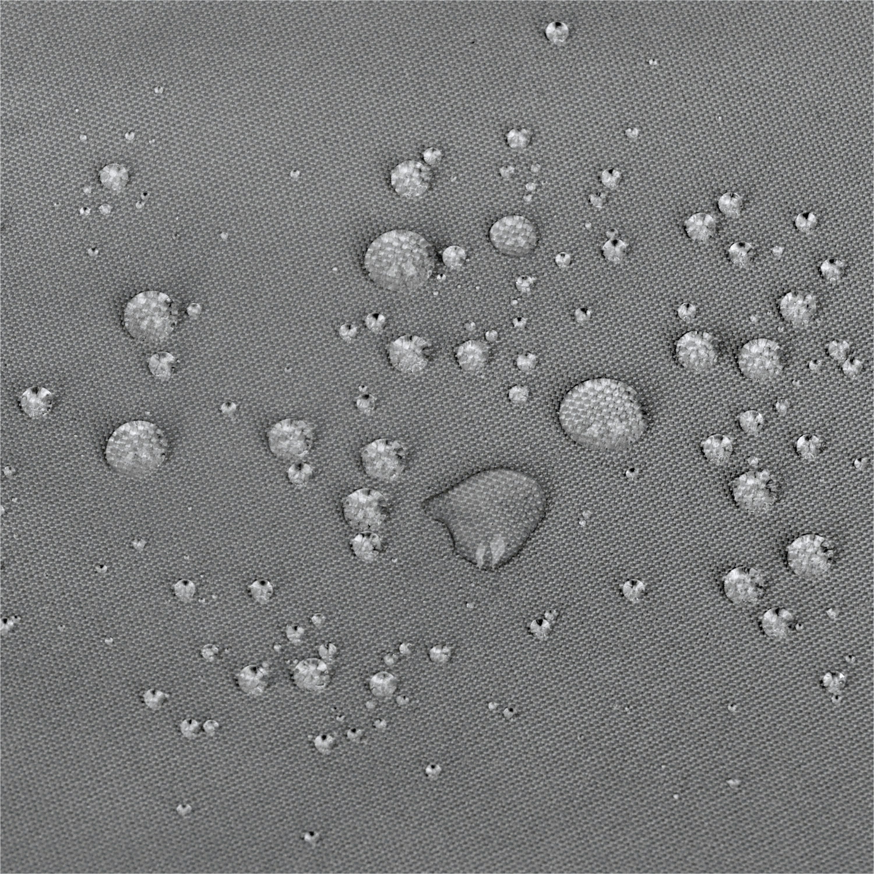 A close-up of a gray textured surface with scattered small raised circular bumps and a few larger bumps, resembling a fabric or material swatch rather than a finished consumer product. 