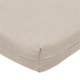 Close-up of a khaki woven fabric cushion corner with stitched edges on a white background. 