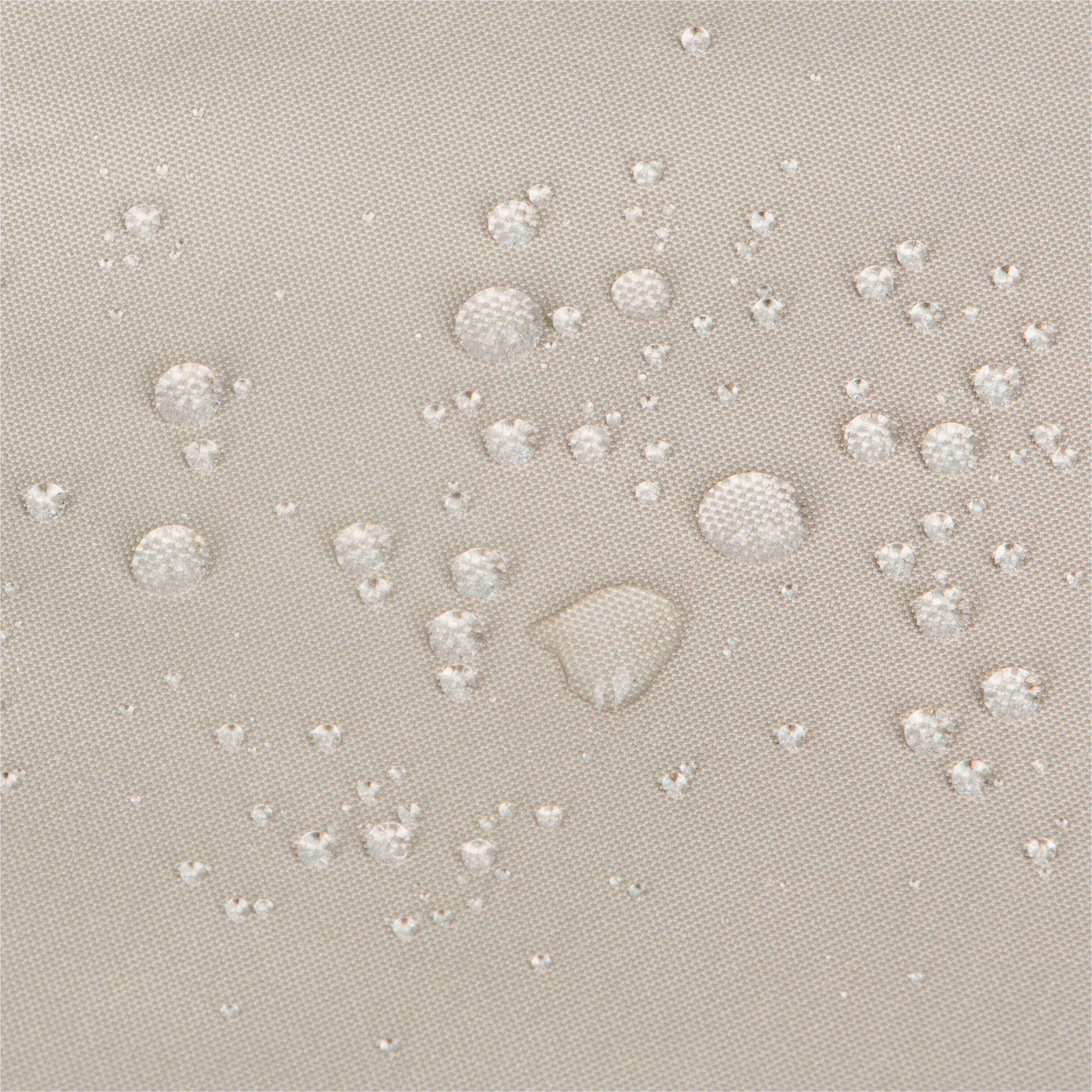 Close-up of a khaki woven fabric surface with multiple clear water droplets resting on top, showing a water-repellent or hydrophobic effect. 