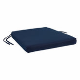 A square navy blue upholstered seat cushion with two black tie straps on the sides, shown on a plain white background. 